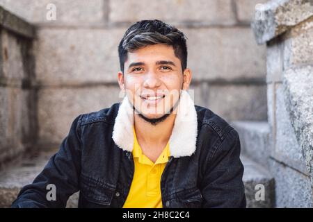 Closeup of the young man looking at the camera and smiling. Stock Photo
