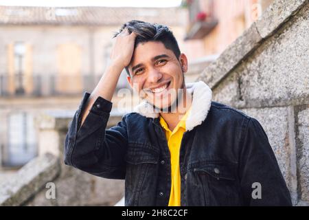Closeup of the young man looking at the camera and smiling. Stock Photo