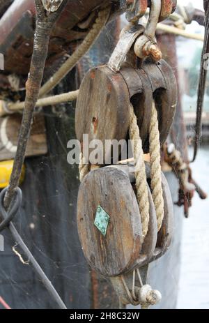 the wooden oval pulleys of a rope on a sailboat Stock Photo