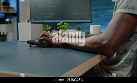 African american person programming codes for firewall server on computer. Black programmer using coding interface with binary code for website development. african american man working with data Stock Photo
