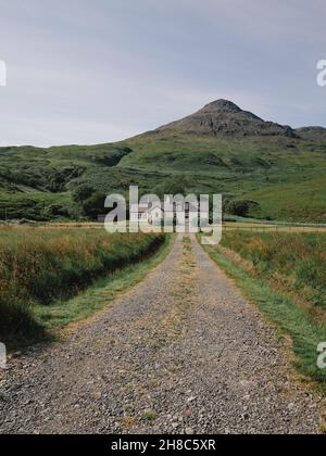 A lone typical white croft house at the end of a track in the remote Inner Hebrides landscape of Mull in Scotland UK - Scotland croft architecture Stock Photo