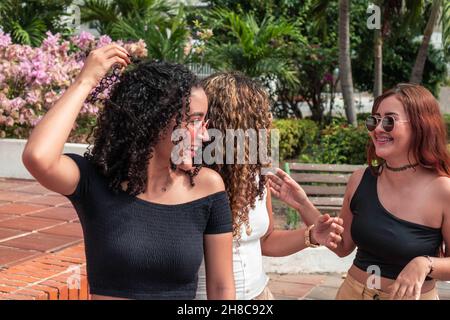 Three Latin friends having fun outdoors Stock Photo