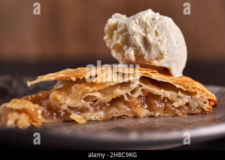 Apple pie with a vanilla icecream on top in closeup Stock Photo