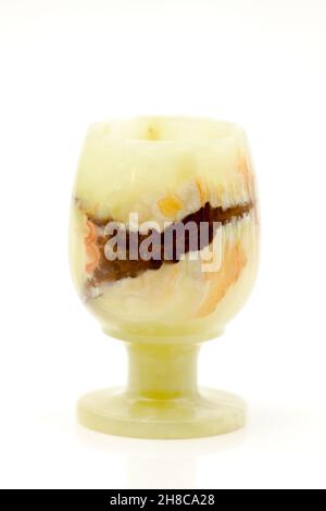 A glass of semi-precious stone onyx with healing and protective forces, according to beliefs. Selective focus with shallow depth of field. Stock Photo