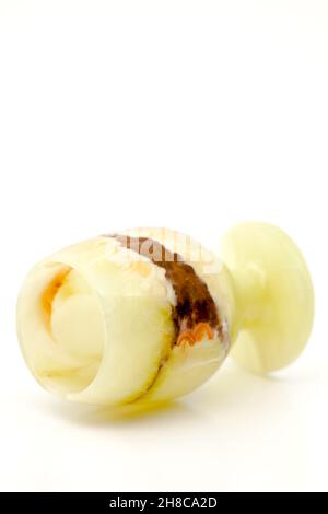 A glass of semi-precious stone onyx with healing and protective forces, according to beliefs. Selective focus with shallow depth of field. Stock Photo
