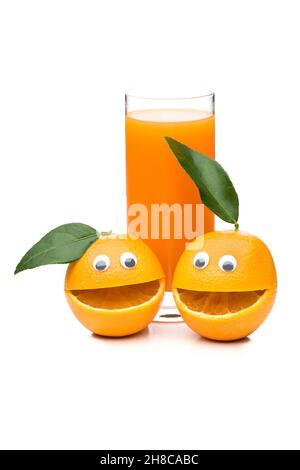 Two smiling oranges with a glass of orange juice Stock Photo