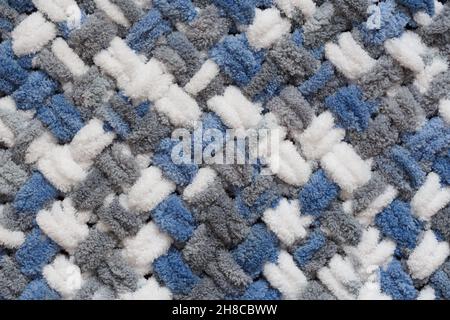 Fluffy knitting structure of gray, blue and white threads, close-up view from the top Stock Photo