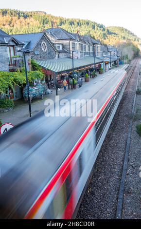 Betwsy Coed railway station with train arriving onto the platform. Stock Photo