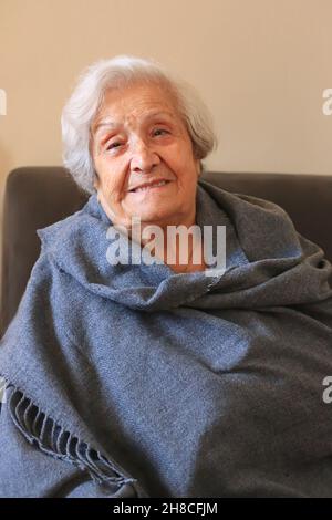 Portrait of a very elderly woman close-up. Positive ninety year old grandmother. Stock Photo