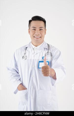 Portrait of positive mature doctor showing thumbs-up, isolated on white Stock Photo