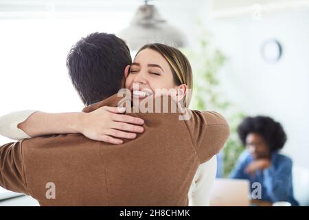 hug hugging coworker love partner office business happy relationship Stock Photo