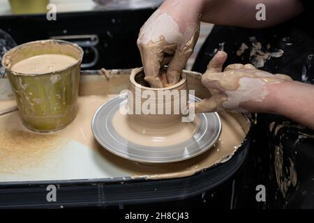 Clay modeling training on a potters wheel, clay master class. Art, creativity. Modeling clay, cultural traditions, hobby Stock Photo