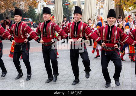 Plovdiv, Bulgaria - November 26, 2021: Young wine parade in the Old Town, traditional folklore dances Stock Photo