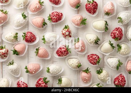 Chocolate dipped strawberries pattern on white planks Stock Photo
