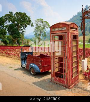 Vertical shot of an old phone booth in the countryside in Thailand