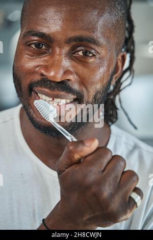 Young African American male brushing his teeth Stock Photo