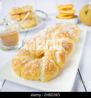 Apple rings in puff pastry, with cinnamon and powdered sugar. Stock Photo