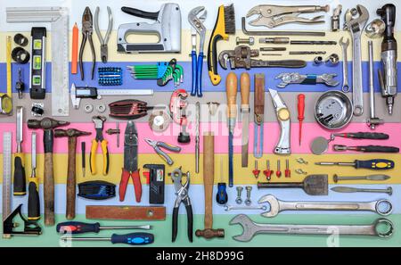 Selection  of  diy hand tools on a multi colour background Stock Photo