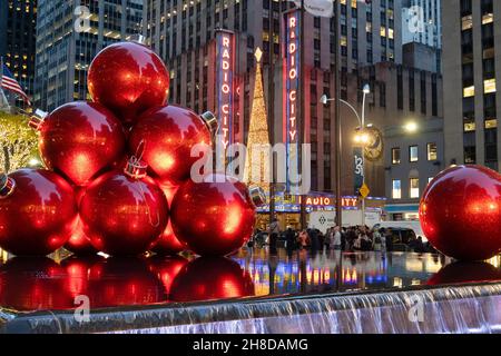 Giant Christmas Ornaments, Reflecting Pool, 1251 Avenue of the Americas with Radio City Music Hall in the background, New York City, USA