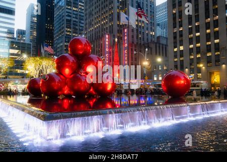 Giant Christmas Ornaments, Reflecting Pool, 1251 Avenue of the Americas with Radio City Music Hall in the background, New York City, USA