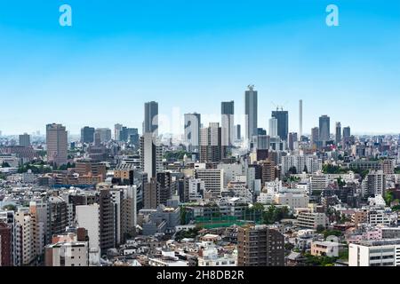 tokyo, japan - may 03 2021: Bird's eye view of a cityscape of the skyscrapers of Ikebukuro district along the horizon line with the landmark of Sunshi Stock Photo