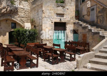 Matera, Italy. Old town restaurant outdoor wooden tables. Stock Photo