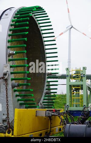 Fastening bolts of a blade from a new wind turbine on an extremely overlong heavy transport truck. German A2 freeway in Hannover district, Germany Stock Photo