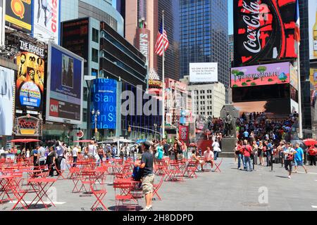 NEW YORK, USA - JULY 7, 2013: People visit Times Square in New York. The square at junction of Broadway and 7th Avenue has some 39 million visitors an Stock Photo