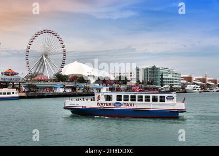 CHICAGO, USA - JUNE 26, 2013: Water taxi approaches the Navy Pier in Chicago. The 3,300-foot pier built in 1916 is one of most recognized Chicago land Stock Photo