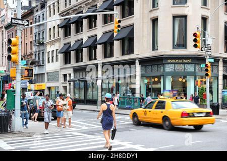 NEW YORK, USA - JULY 4, 2013: People walk in Lower Manhattan in New York. Circa 19 million people live in New York City metropolitan area. Stock Photo