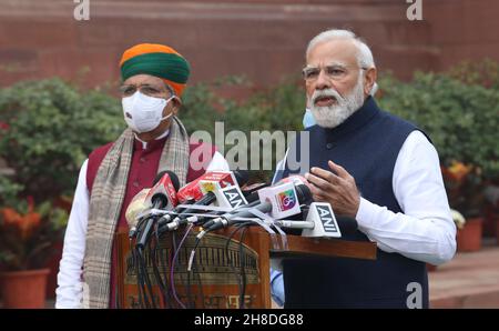 Indian Prime Minister, Narendra Modi (R) addresses the media on the first day of the Parliament Winter Session in New Delhi.Government repeals the three farm laws in the Lok Sabha and Rajya Sabha ahead of the parliament session. The Lok Sabha passed the bill repealing the three farm laws amid sloganeering by the Opposition. Farmers have been protesting against these three agriculture bill for nearly a year and demand for the Minimum Support Price (MSP). In this session from 29th November to 23rd December 2021, 26 other bills are listed for introduction in the Parliament. Stock Photo