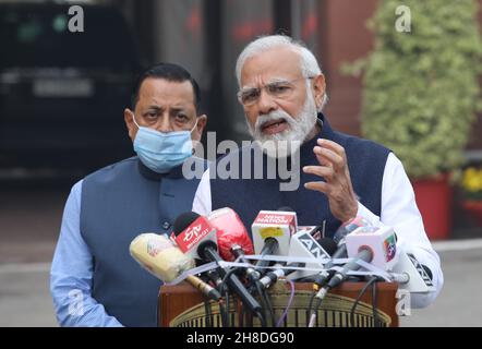 Indian Prime Minister, Narendra Modi (R) addresses the media on the first day of the Parliament Winter Session in New Delhi.Government repeals the three farm laws in the Lok Sabha and Rajya Sabha ahead of the parliament session. The Lok Sabha passed the bill repealing the three farm laws amid sloganeering by the Opposition. Farmers have been protesting against these three agriculture bill for nearly a year and demand for the Minimum Support Price (MSP). In this session from 29th November to 23rd December 2021, 26 other bills are listed for introduction in the Parliament. Stock Photo