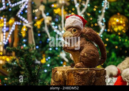 Christmas squirrel on blurry Christmas tree decoration background Stock Photo