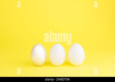 Easter colored bright eggs on a yellow background. Easter creative banner concept card. Copy space Stock Photo