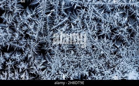 Texture pattern of snowflakes of crystals of snow on glass. Selective Focus. Winter textures, backgrounds patterns. Copy space Stock Photo
