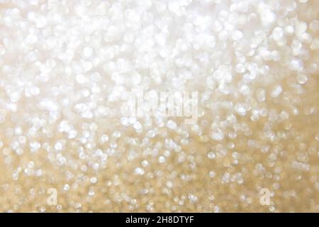 Bokeh, defocus background. Glare bokeh passing from silver white to gold. Festive background. Vertical orientation. Copy space Stock Photo