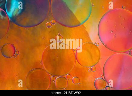 Abstract background of light orange and pink colors of oil drop floating on water Stock Photo