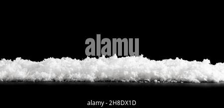 Close white snow isolated on black background Stock Photo