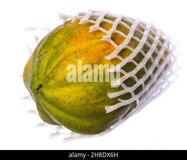 intact whole papaya in a plastic net isolated on white background Stock Photo