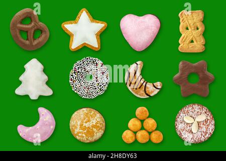 Various Christmas cakes and sweets against green background Stock Photo