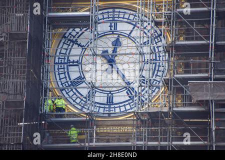 London, UK. 26th November 2021. Workers renovate the clock face as refurbishment of Big Ben continues. The renovation of the iconic landmark is expected to be completed in 2022. Stock Photo