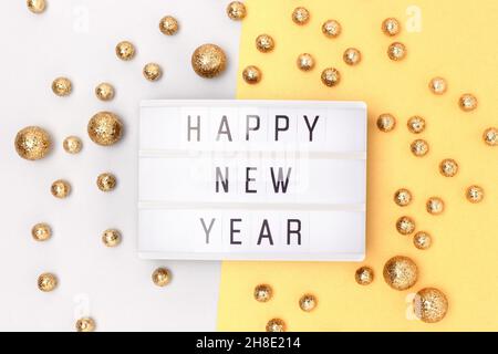 Happy New Year. Lightbox and golden round glittering confetti. Stock Photo