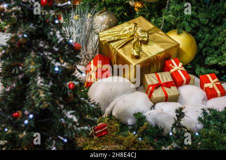 gift boxes in wrapping paper under the Christmas tree Stock Photo