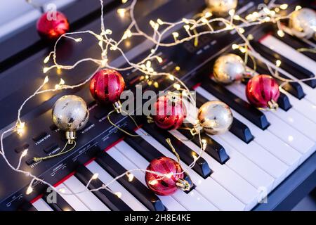 A colorful chain of lights lies on piano keys Stock Photo