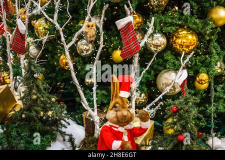 Christmas decoration with gift boxes and Christmas characters under the fir tree Stock Photo