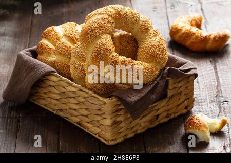 Traditional Turkish simits with sesame seeds on a wooden background. Rustic style. Stock Photo