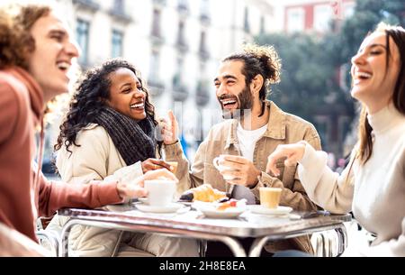 People group drinking cappuccino at coffee bar patio - Friends talking and having fun together at sidewalk cafeteria - Life style concept Stock Photo