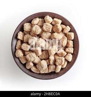 Cubes of brow cane sugar in ceramic bowl isolated on white background with clipping path Stock Photo