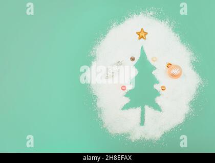 Pastel mint concept. Christmas tree silhouette. with copy space. New Year's decorations in caramel and pastel color. Pearl white silver cone. Small ba Stock Photo