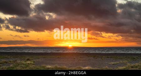 Sun going down on the Ballantrae Bay Beach in scotland Stock Photo